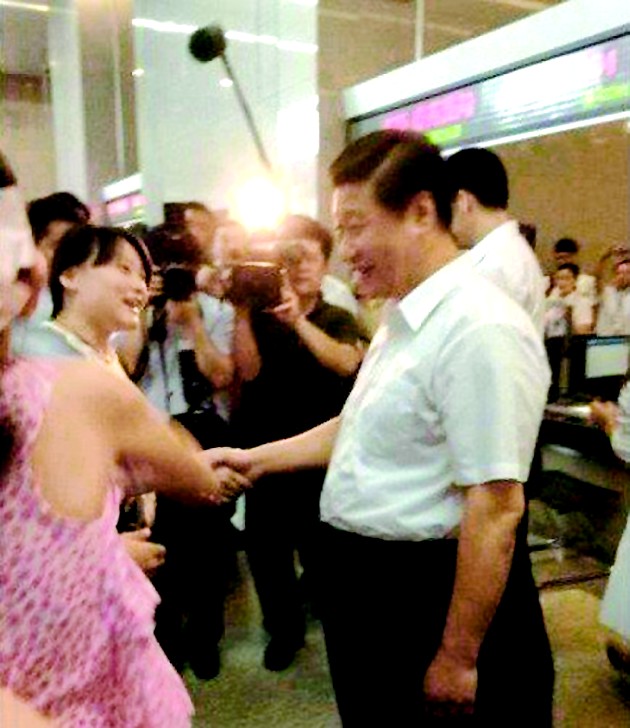 图为:习近平在武汉市民之家,与市民郭婷婷握手时,亲切地问候道:“美女,你好!”周围的群众都笑了。