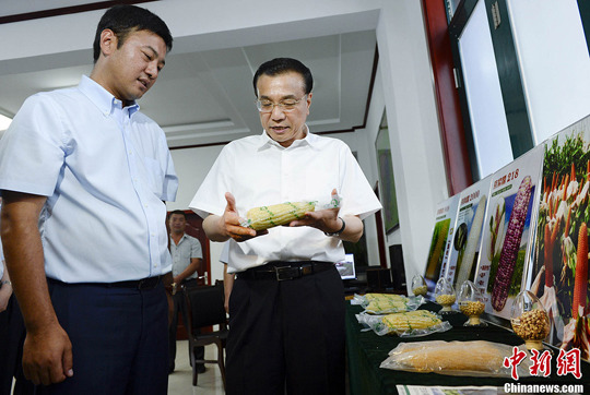 图为李克强2014年7月24日到山东德州陵县,“全流程”考察德强现代家庭农场。中新社记者 刘震 摄